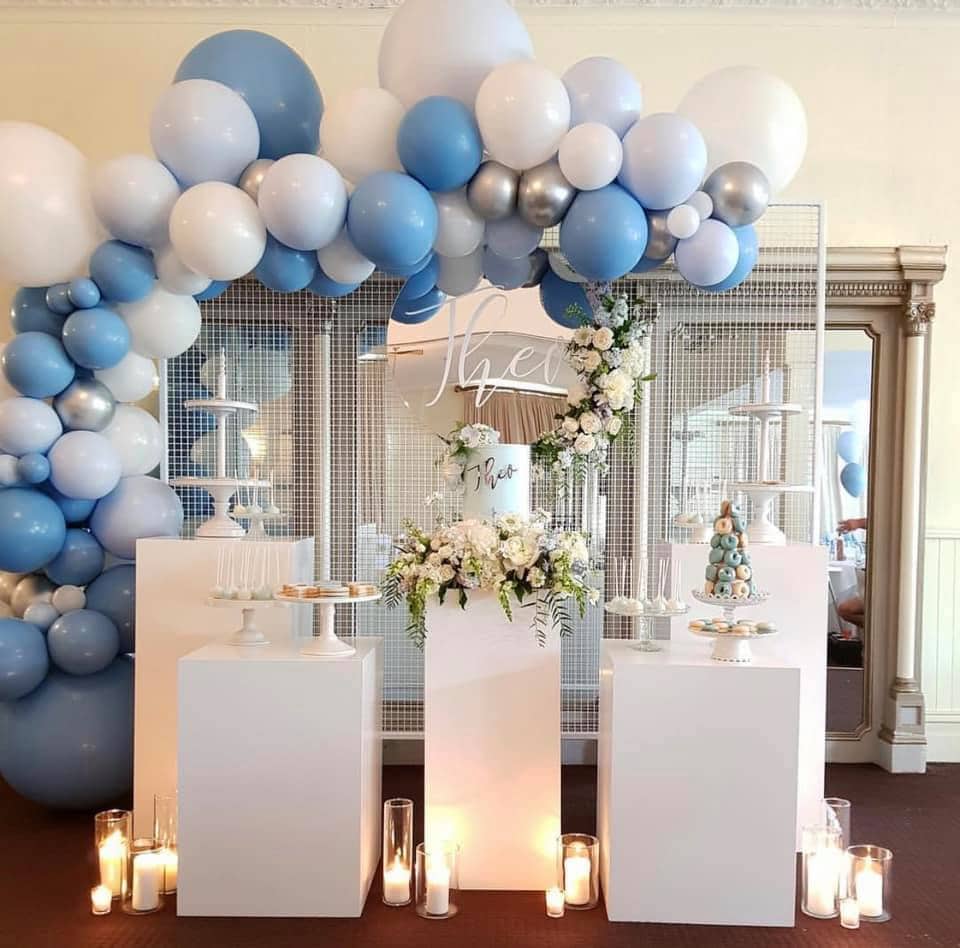 Balloons and cake styled for a gender reveal celebration